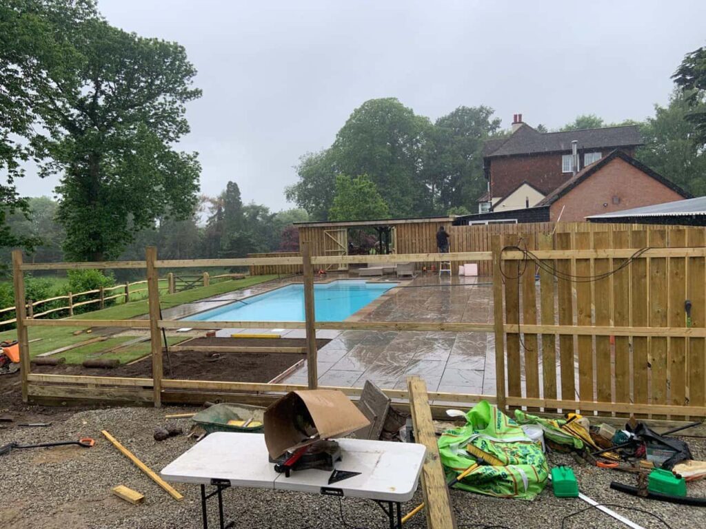 This is a photo of Bespoke custom fencing installed around a swimming pool by Fast Fix Fencing Kings Lynn